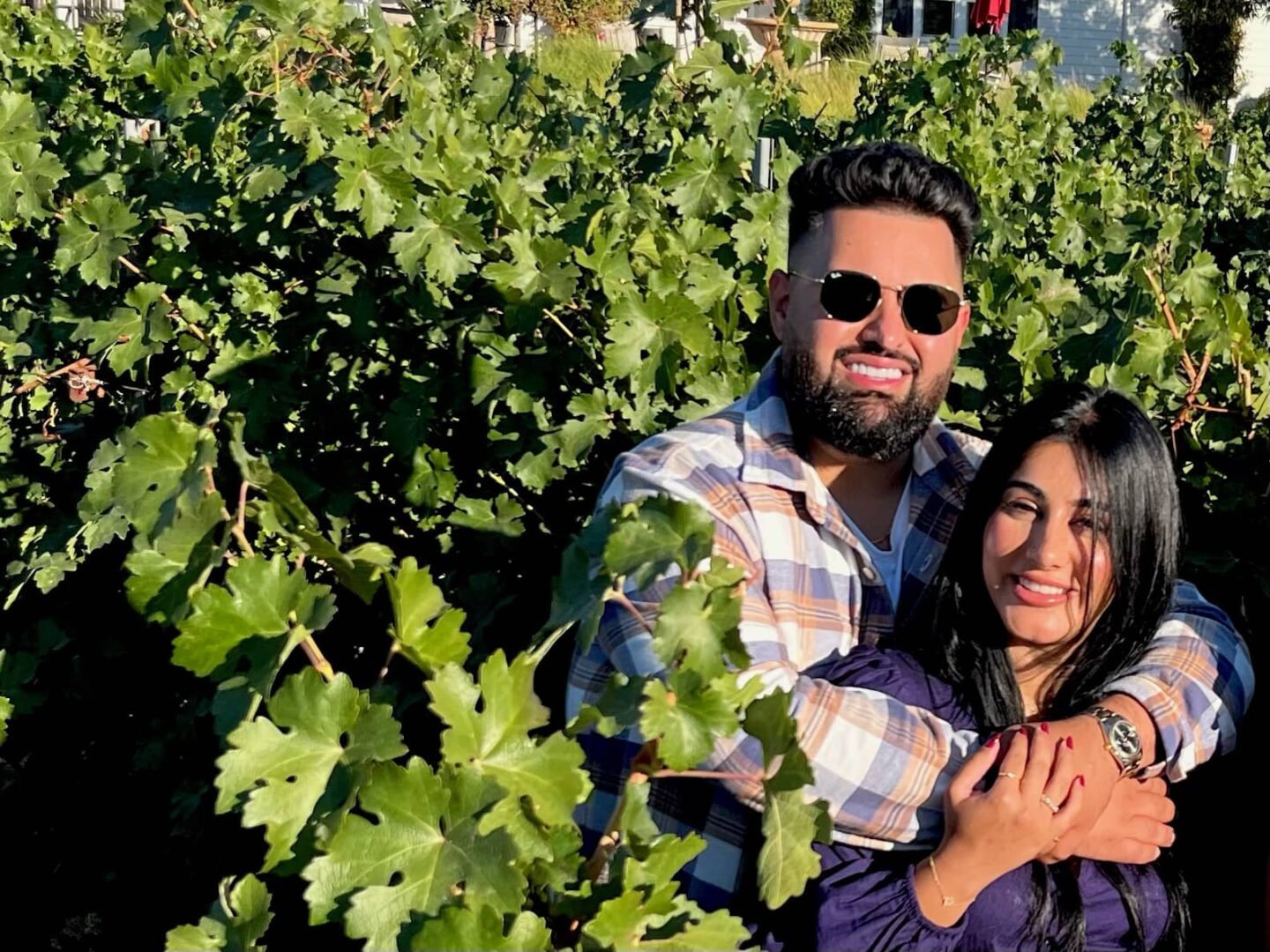 a latina couple on a wine tour in paso robles on their romantic getaway in a vineyard