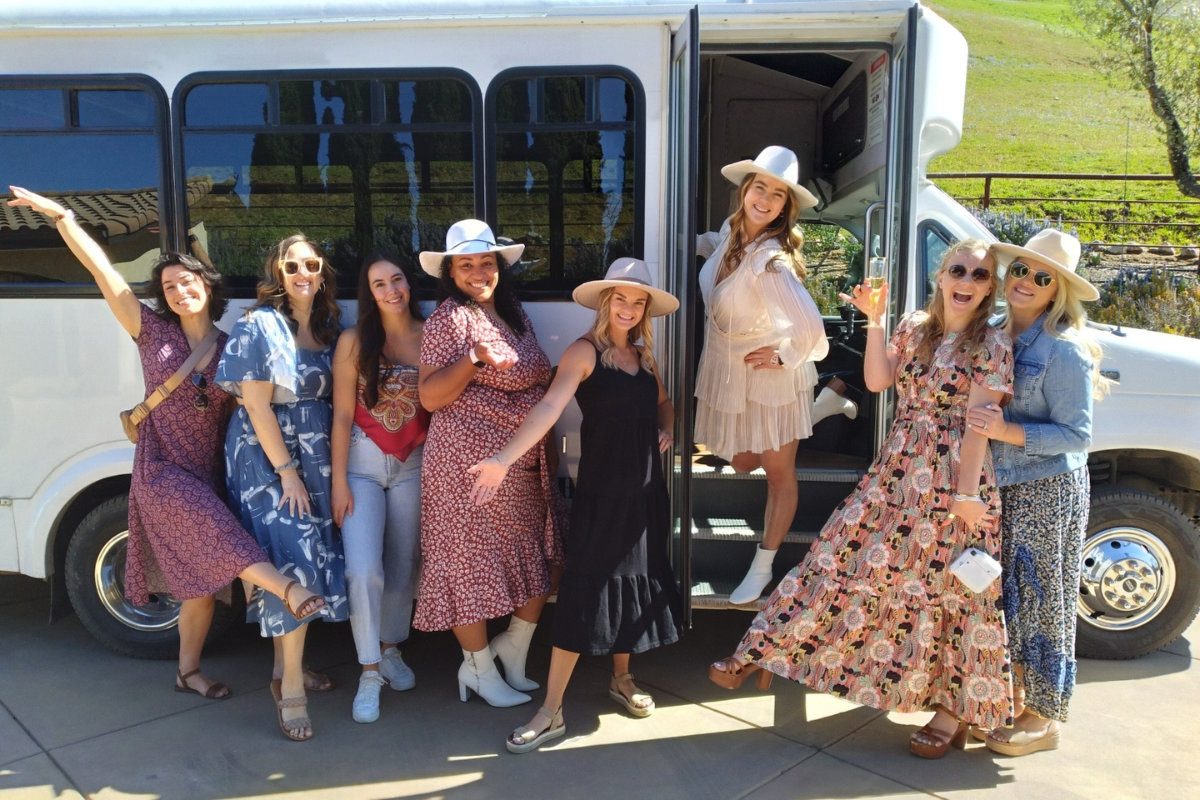 group of women outside of a wine tour transportation vehicle in paso robles