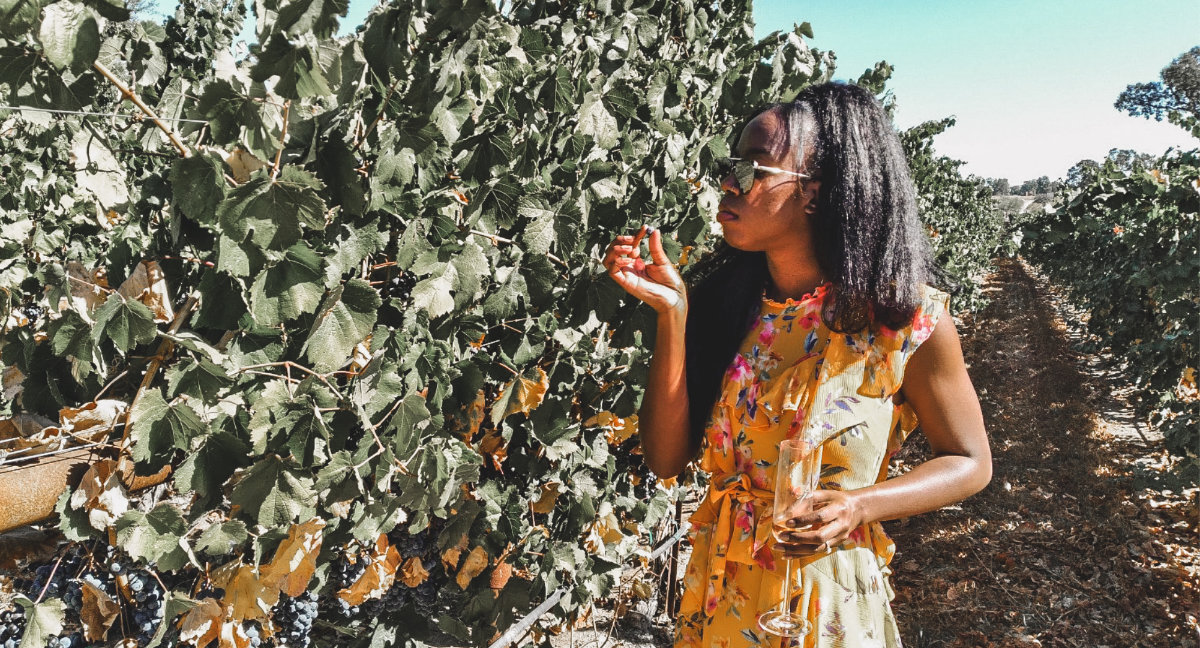 Girl smelling grape vines