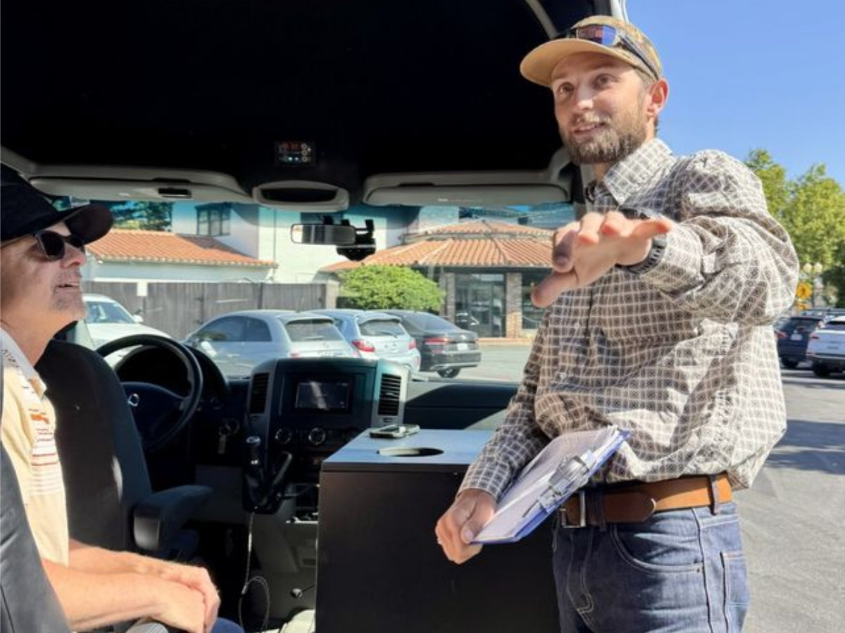 tour guide in sprinter van talking to group